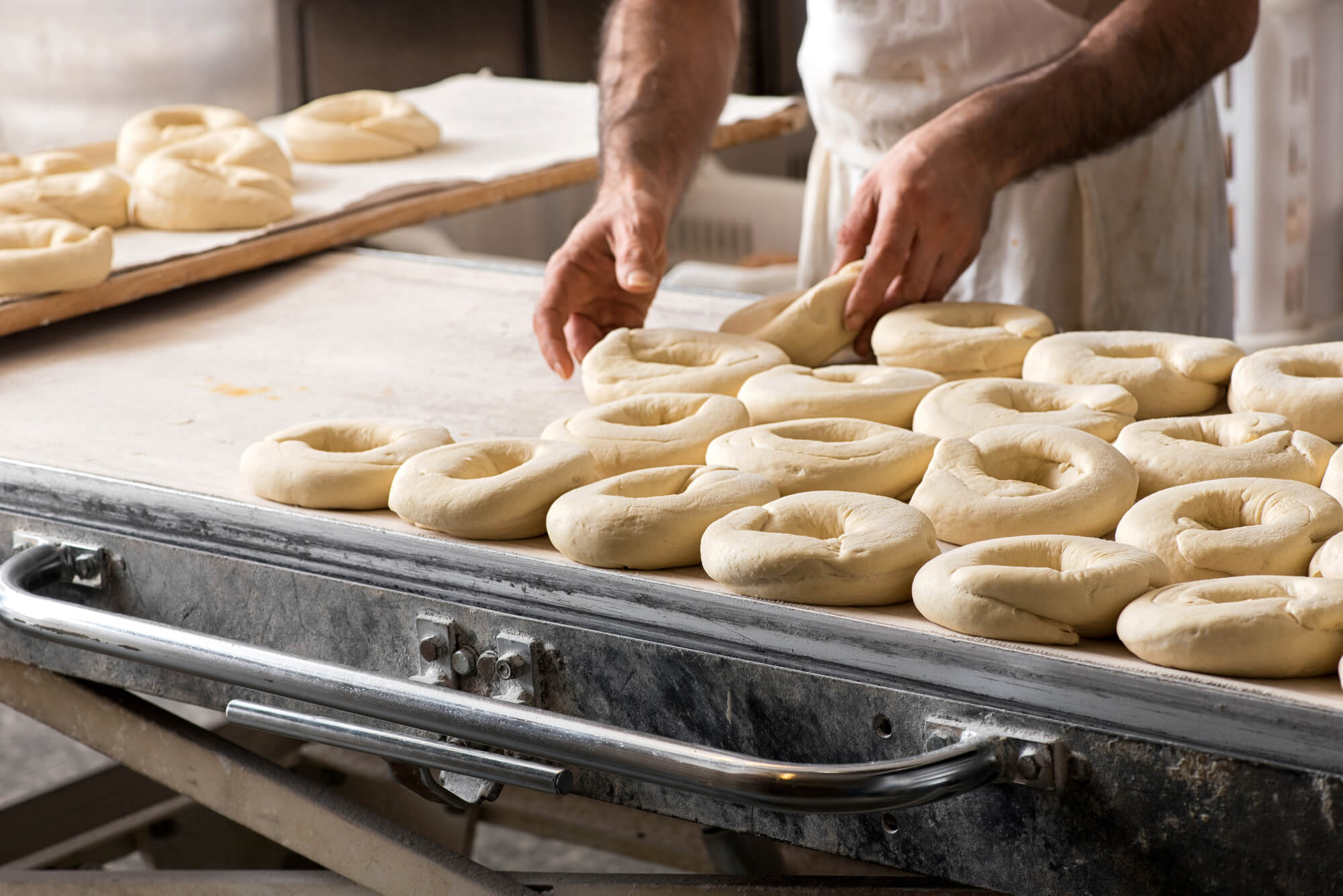 Baker preparing dough for bagels before using Bagel Bag Closing Machines