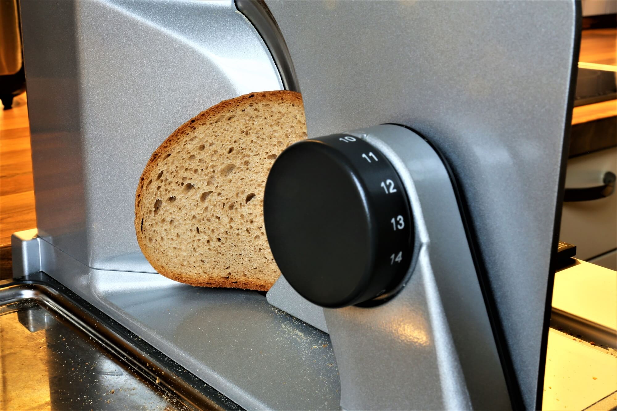a photo of a bread slicer equipment with a sliced bread